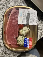 Beef petite sirloin steak with mozzarella and spinach, stuffed mushrooms, and to