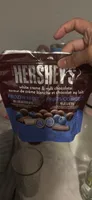 Frozen fruit blueberries enrobed in white creme and milk chocolate
