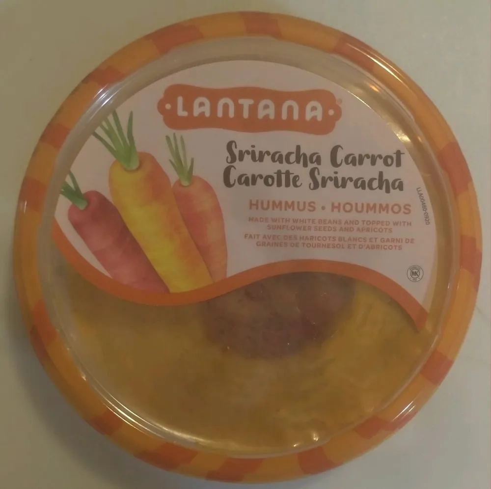 Sriracha Carrot Hummus made with White Beans and topped with Sunflower Seeds and Apricots
