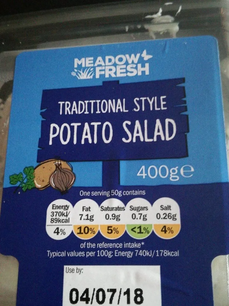 Diced potato and onion in mayonnaise with parsley