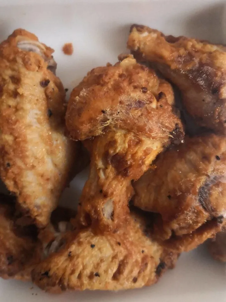 Ali di pollo speziate cotte