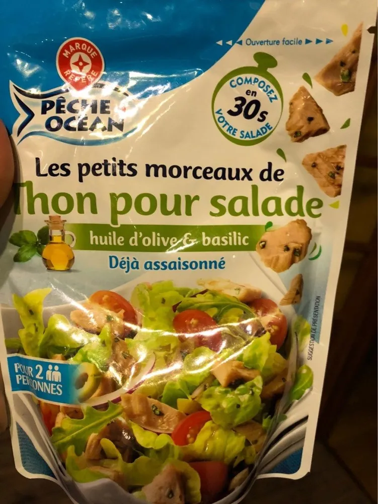 Préparation salade aux morceaux de thon huile d'olive et basilic