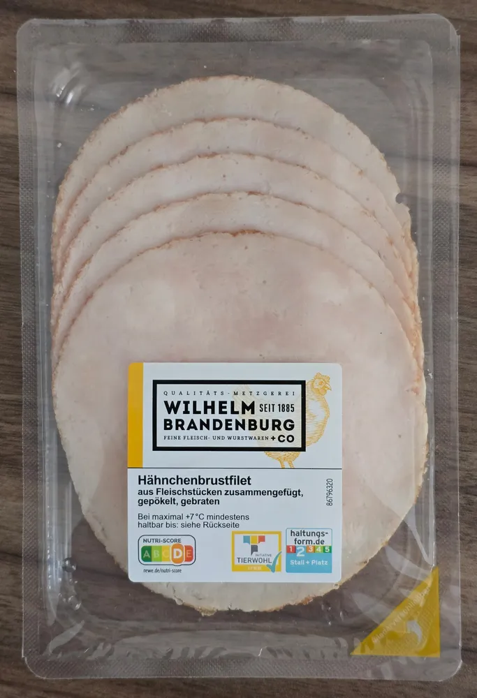 Hähnchenbrustfilet aus Fleischstücken zusammengefügt, gepökelt, gebraten