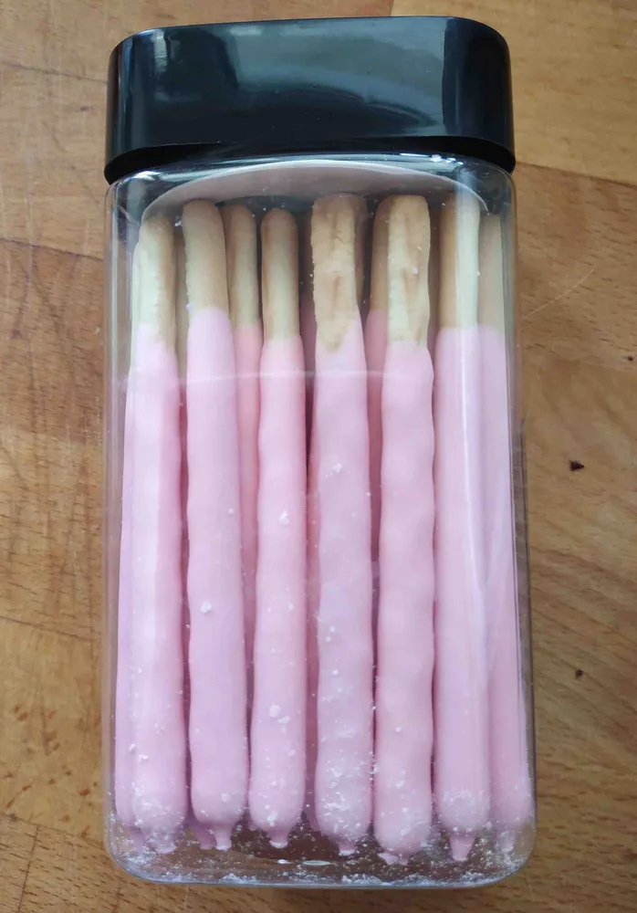 Palitos de galletas cubiertas de chocolate con sabor a fresa